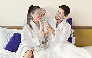 Loving couple having a lazy morning breakfast in bed