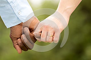 Loving couple holding hands.