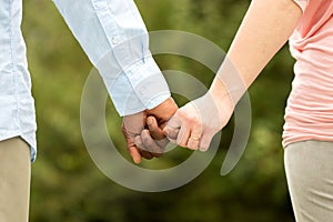 Loving couple holding hands