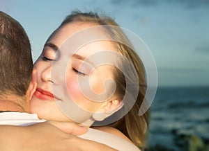 Loving couple hugging with focus on woman's face