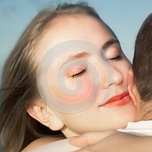 Loving couple hugging with focus on woman's face