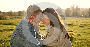 Loving couple hugging and kissing on meadow