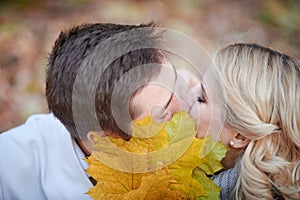 Loving couple kissing in autumn park