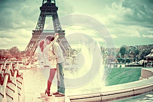 Loving couple kissing near the Eiffel Tower in Paris