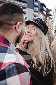 Loving couple kissing outdoor. Cute couple of hipsters is walking in spring park. Beautiful sunny day. Walking on the city`s