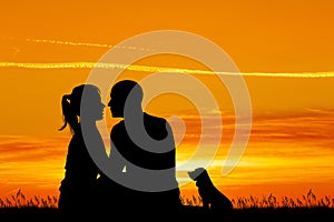 Loving couple kissing at sunset