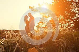 Loving couple kissing at sunset