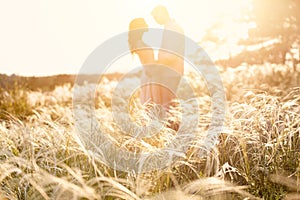 Loving couple kissing at sunset, focus on foreground