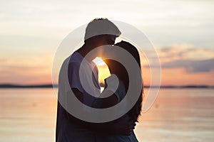 Loving couple kissing at sunset. love in the sun. Valentine`s day in nature