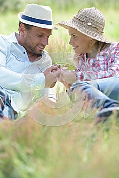 loving couple layed in long grass