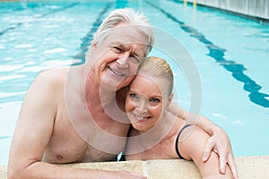 loving couple leaning at poolside