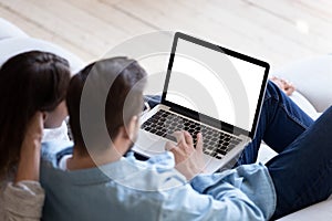 Loving couple looking at laptop screen blank white mockup