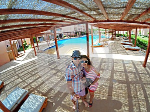 Loving couple making selfy near swimming pool