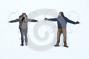 Loving couple making snow angel