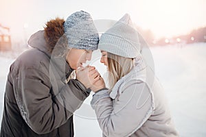 Loving couple man and girl warm each other hands in cold in winter, concept help and support family relationships