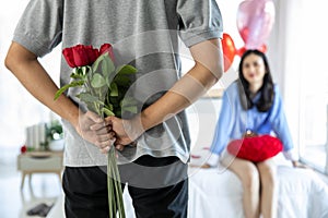 Loving couple  Man with rose and gift on back in bedroom valentines day concept