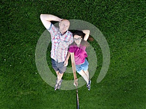 Loving Couple man and woman lying on the green grass