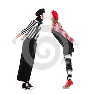 Loving couple of mimes kissing