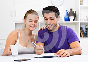 Loving couple with papers at home