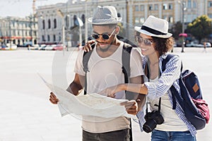 Loving couple planning walk route with map