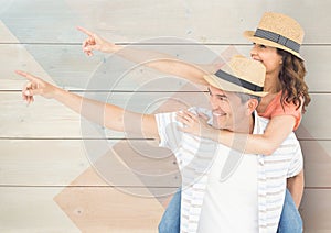 Loving couple pointing against wooden background