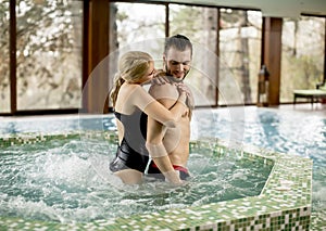 Loving couple relaxing in hot tub