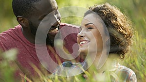 Loving couple relaxing outside on picnic in city park, having fun together