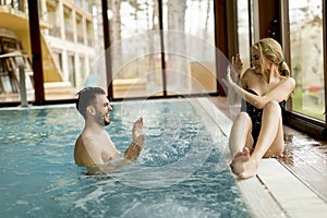 Loving couple relaxing in the spa by the pool