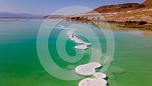 Loving couple is resting on the dead sea. Salt coastline, The sea in Israel dies out and dries up