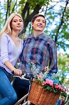 Loving couple with retro bikes in the park, happy.