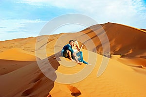 Loving couple in the Sahara Desert. Morocco