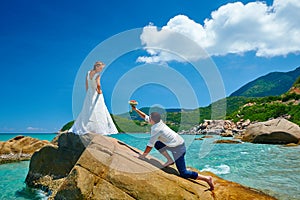 Loving couple on sea beach - a man making proposal with bouquet