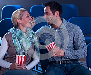 Loving couple sharing their popcorn