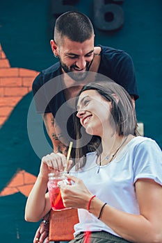 Loving couple sitting in a cafe drinking juice and enjoying in conversation