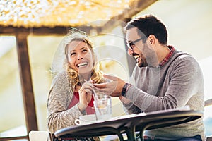 Loving couple sitting in a cafe enjoying in coffee and conversation