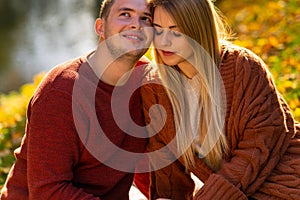 Loving couple sitting with cheeks touching.