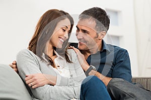 Loving Couple Sitting On Couch