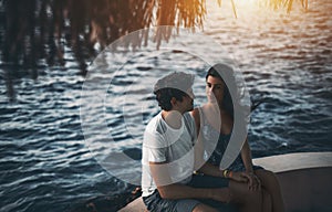 Loving couple sitting on resort pier