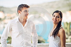 Loving couple spending vacation on tropical resort swimming pool.Newlyweds honeymoon on seaside