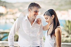 Loving couple spending vacation on tropical resort swimming pool.Newlyweds honeymoon on seaside