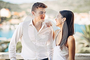 Loving couple spending vacation on tropical resort swimming pool.Newlyweds honeymoon on seaside