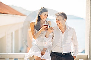 Loving couple spending vacation on tropical resort swimming pool.Newlyweds honeymoon on seaside