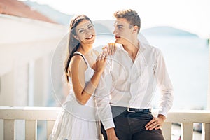 Loving couple spending vacation on tropical resort swimming pool.Newlyweds honeymoon on seaside