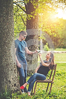 Loving couple in spring park, playing while waiting their son