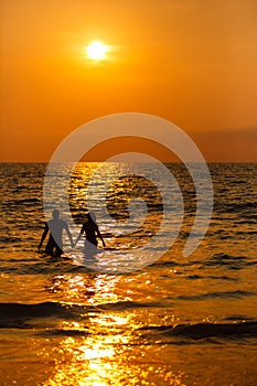 Loving couple at sunset in the sea