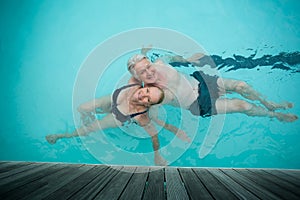 loving couple swimming in pool