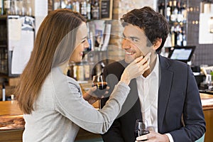 Loving couple takes a drink in restaurant, a tender moment