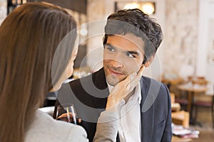 Loving couple takes a drink in restaurant, a tender moment