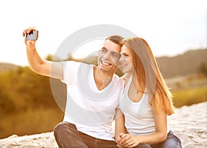 Loving couple taking selfie in the park