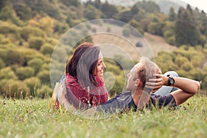 Loving couple tender conversation at the green meadow in country